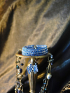 Frostwarden earrings and bracelet on silver candle stand