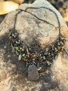 Handmade tatted necklace featuring lava stone centerpiece