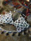 Close-up of silver Celtic knot earrings
