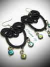 Black tatted earrings with blue-gold beads on white background