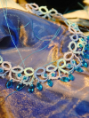 Aqua crystal drops hang from tatted loops in ocean colors