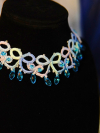 Close-up of blue and green lace necklace with crystal drops