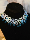 Hand-tatted necklace featuring faceted ocean-blue drops