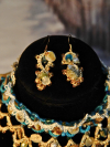 Close-up of Sandy Treasures earrings with ocean blue beads, pearls, and shells.