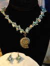 Hand-tatted lace necklace with aqua beads, seashells, and silver clasp.