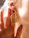 Model wearing hand tatted golden lace rose earrings