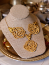 Golden lace rose necklace styled with vintage-inspired decor