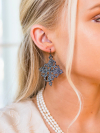 Dark Gray lace earrings framed by blonde hair and pearls