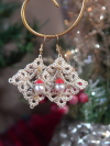 Handmade tatted lace earrings with Santa-themed bead accents displayed on a holi
