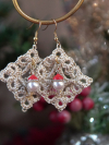 Lightweight tatted lace earrings with Santa hat drops captured in a winter-theme