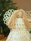 White tatted angel tree topper with detailed lace wings and skirt