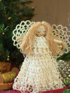 Victorian-style white tatted angel tree topper with lace skirt