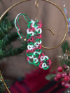 Small red green and white lace stocking ornament displayed with Christmas décor