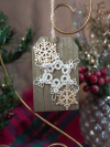 White lace snowflake on wooden ornament