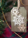 Handmade lace snowflake on rustic wood tag