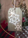 White tatted snowflake ornament on wood tag