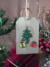 Handmade tatted tree ornaments on wood tags with glittered presents