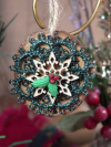 Wooden ornament with green tatted wreath and holly leaves with red berries