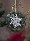 Small wooden ornament with green tatted wreath and layered glitter snowflake