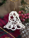 White tatted lace bell ornament hanging on gold display