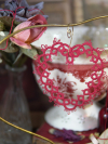 Handmade lace heart displayed in Valentine-themed scene