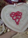 Red tatted lace heart displayed on embossed ceramic heart dish
