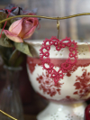 Handmade lace heart displayed in Valentine-themed setting