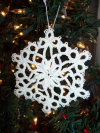 Detailed white tatted snowflake ornament made in cotton thread