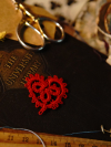 Red tatted lace heart resting on vintage book cover
