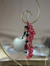 Close-up of red lace keychain with dark gemstone drops
