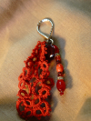 Detailed view of red lace keychain with heart bead