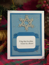 Hand-tatted lace snowflake notecard displayed with layered blue winter cardstock