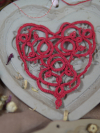 Flat-lay of tatted lace heart ornament named Wortbild