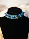Handmade sea-glass bead choker in sea-blue thread and black glass.