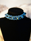 "Tidebound Sentinel" by A Knotted Life Jewelry Handmade sea-glass bead choker in sea-blue thread and black glass.