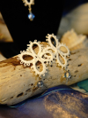 Tidecross earrings tatted in white lace with blue glass beads