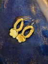 Tidepetal earrings displayed on shimmering blue fabric.