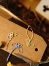 Multicolored tatted butterflies on a kraft tag