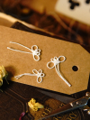 White tatted butterflies on kraft tag with dried flowers