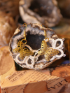 Tatted lace earrings with brass butterfly centers.
