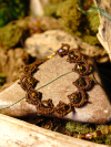 Brown tatted bracelet with shimmering beads in nature
