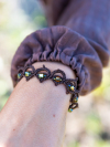 Earthy lace bracelet with gold sparkle in soft outdoor light