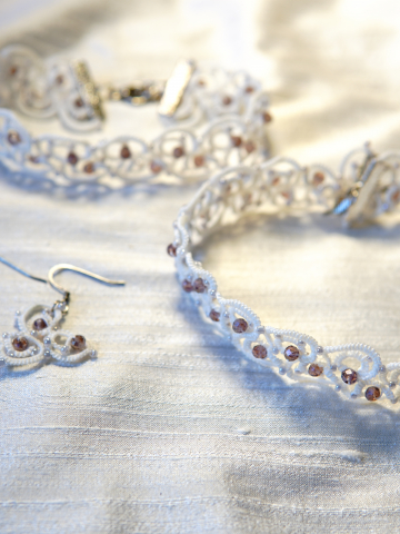 Elarian Bloom necklace resting on a shimmering cloth.