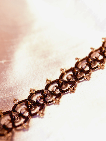 Brown lace and gold crystal bracelet on fabric
