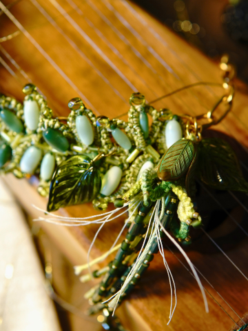 Close-up of Seralith necklace showing glass leaves and beadwork