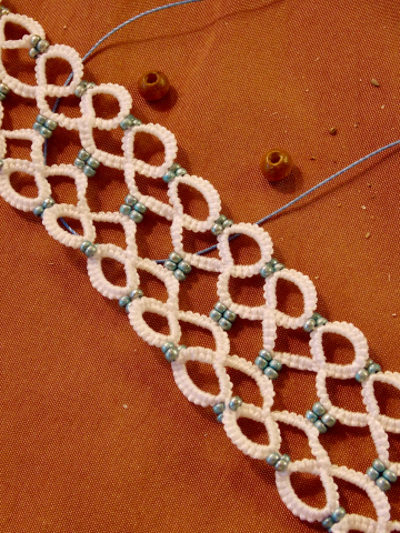 Snowmelt Whisper Tatted Lace Bracelet across warm fabric