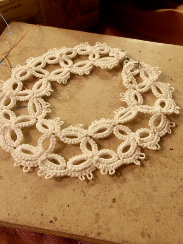 Close-up of cloudlike needle tatting with soft open ringwork.