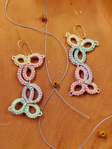 Tatted lace earrings in pastel ombre on parchment background