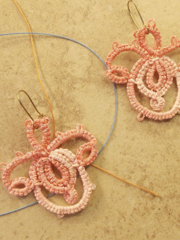 pink tatted earrings shaped like layered open petals