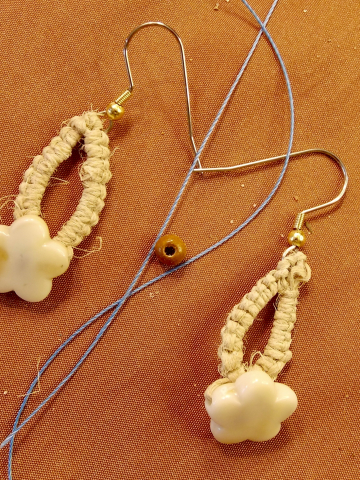 Ocean-inspired earrings with golden shell beads and loops.